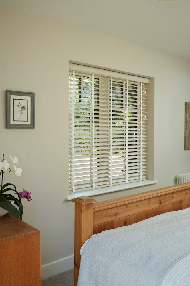 Faux wood venetian blinds fitted in a bright room
